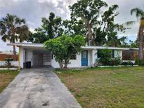 Cozy single-story home with a well-maintained lawn and mature trees providing shade at 4712 Cronin Dr, Sarasota, FL 34232