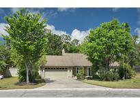 Charming single-story home featuring a two-car garage, well-maintained lawn, mature landscaping, and a driveway at 5607 78Th E Ave, Palmetto, FL 34221
