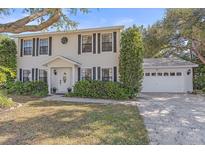 Two-story home featuring well-maintained landscaping and an attached two-car garage at 5766 Forester Pine Ct, Sarasota, FL 34243