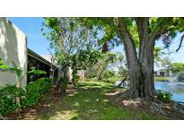 Serene backyard featuring lush greenery, a tranquil pond, and mature trees, creating a private oasis at 631 Woodlawn Dr, Bradenton, FL 34210