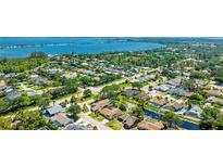 Stunning aerial view of a single-Gathering home in a lush community near the water, boasting a backyard pond at 914 82Nd Nw St, Bradenton, FL 34209