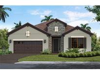 Charming single-story home with stone accents, a tile roof, a two-car garage, and a landscaped front yard at 11008 Hogan Cir, Englewood, FL 34223