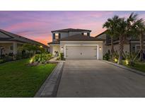 Charming two-story home with well-manicured lawn, fresh landscaping, and a two car garage at 16226 Paynes Mill Dr, Bradenton, FL 34211