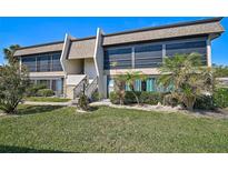 Inviting condo featuring well-maintained landscaping, a modern exterior, and an appealing staircase entrance at 1697 Northampton St # 1699-D, Venice, FL 34293