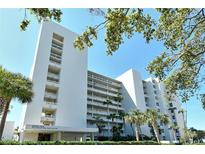 Building Three boasts tropical landscaping, bright white facade, and multiple private balconies at 230 Sands Point Rd # 3501, Longboat Key, FL 34228