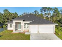 Beautiful single-story home featuring a two-car garage and well-manicured lawn at 3694 Crittendon St, North Port, FL 34286