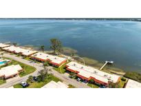 Scenic aerial view of waterfront condos with private dock access and lush landscaping along the Tampa Bay at 3859 Catalina Dr, Bradenton, FL 34210