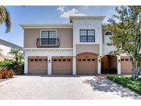 Charming townhome showcasing multiple garages, beautiful brick driveway and manicured landscaping at 4069 Overture Cir # 341, Bradenton, FL 34209
