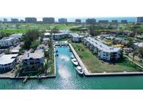 Stunning aerial view of the community with boat docks, waterfront condos, and lush landscaping at 450 Gulf Of Mexico Dr # B207, Longboat Key, FL 34228