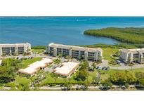 Beautiful bayfront villas with mature trees, manicured lawns, and convenient parking at 4760 Gulf Of Mexico Dr. Villa 7, Longboat Key, FL 34228