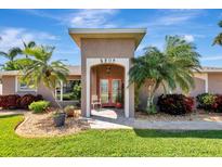 Inviting front entrance features double doors, palm trees and well-manicured landscaping at 5209 26Th W Ave, Bradenton, FL 34209