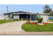 Charming single-story home with a well-manicured lawn and a curved driveway at 5727 25Th W St, Bradenton, FL 34207