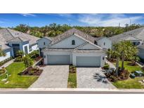 Charming home featuring a well-manicured lawn, paver driveway, and two-car garage at 6255 Cassia St, Bradenton, FL 34203