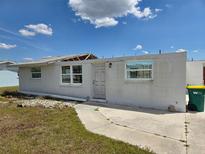Exterior view of the house with a cracked foundation and showing signs of deterioration needing repair at 2061 Georgia Ave, Englewood, FL 34224