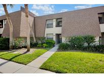 Charming condo with lush landscaping, a well-maintained lawn, and beautiful flowering shrubs at 4632 Ringwood Mdw # 28, Sarasota, FL 34235
