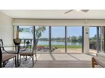 Bright dining area with waterfront views through sliding glass doors, allowing abundant natural light to fill the space at 515 Spring Lakes Blvd # 515, Bradenton, FL 34210