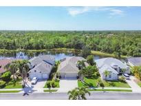 Gorgeous single Gathering home with lush landscaping, mature palm trees, and stunning water view at 7816 Ashley Cir, University Park, FL 34201