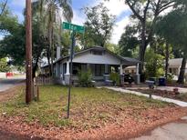 Charming single-story home with a cozy front porch and mature trees. Located at the corner of E Ida Street at 1002 E Ida St, Tampa, FL 33603