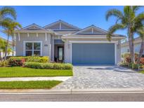 Charming single Gathering home with paver driveway, lush landscaping and a two-car garage at 17675 Azul Dr, Lakewood Ranch, FL 34202
