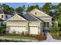 Charming single-Gathering home featuring a well-manicured lawn, stone accents, and a spacious two-car garage at 21221 Wacissa Dr, Venice, FL 34293