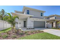 Charming two-story home with grey siding, a two-car garage, and a well-manicured lawn at 2926 River Run Way, Bradenton, FL 34208