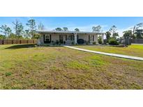 Charming single-story home with a welcoming front porch and spacious yard at 29527 Maris Dr, Punta Gorda, FL 33982
