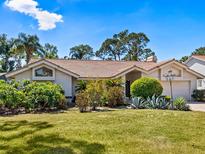 Charming single-story home with well-manicured lawn and mature landscaping creating great curb appeal at 3786 Surrey Ln, Sarasota, FL 34235
