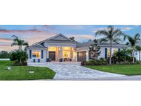 Beautiful single-story home boasts a manicured lawn and elegant paver driveway at 3811 158Th Avenue E Cir, Parrish, FL 34219