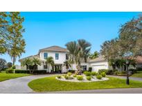 Stunning two-story white home with well-manicured front yard and circular driveway at 4104 Las Palmas Way, Sarasota, FL 34238