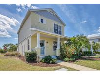 Charming two-story home with a welcoming front porch, lush landscaping, and a well-maintained lawn at 5532 River Sound Ter, Bradenton, FL 34208