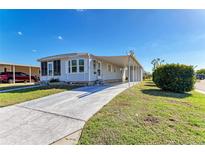 Charming single-story home with a long driveway and well-maintained landscaping at 5619 Bayshore Rd # 152, Palmetto, FL 34221