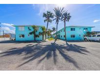 Charming light blue two-story building with palm trees, and ample parking at 117 7Th N St # 35, Bradenton Beach, FL 34217