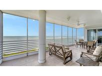 This covered balcony features tile floors, a ceiling fan, and expansive views of the waterfront at 2450 Harbourside Dr # 251, Longboat Key, FL 34228