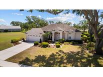 Charming single-story home with well-manicured landscaping, inviting curb appeal, and an attached two-car garage at 3859 Little Country Rd, Parrish, FL 34219