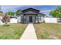 Charming single-Gathering home featuring updated facade, landscaped front yard, and walkway to covered entrance at 4501 20Th S Ave, St Petersburg, FL 33711