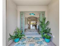 Inviting entryway featuring tiled flooring, potted plants, and an open view to the living area at 4607 Benito Ct, Bradenton, FL 34211