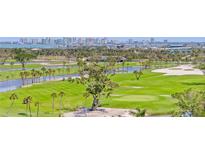 Beautiful golf course with lush green fairways, mature trees, and stunning city views in the distance at 545 Sanctuary Dr # B806, Longboat Key, FL 34228