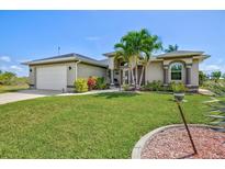 Beautiful single-story home with a well-manicured lawn and tropical landscaping at 8058 Santa Cruz Dr, Port Charlotte, FL 33981