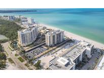 Stunning aerial view of the beach condos and turquoise ocean waters at 1212 Benjamin Franklin Dr # 708, Sarasota, FL 34236