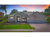Charming one-story home features a well-manicured lawn, beautiful landscaping, and a three-car garage at 12628 Daisy Pl, Bradenton, FL 34212