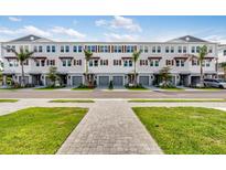 Charming three-story townhomes boast a modern facade, complemented by lush landscaping and private garages at 1620 Sea Haven Dr # 404, Punta Gorda, FL 33950