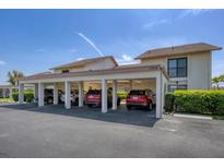 Exterior of home featuring assigned covered parking at 1759 Lake Pl # 1759-B, Venice, FL 34293