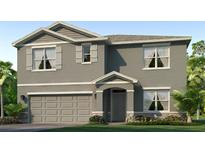 Charming two-story home featuring a gray stucco exterior, a two-car garage, and lush landscaping at 18211 Canopy Pl, Lakewood Ranch, FL 34211