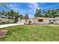 Charming single-story home with well-manicured lawn and lush landscaping on a sunny day at 2924 Valley Forge St, Sarasota, FL 34231