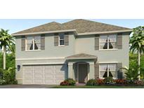 Charming two-story home with a light blue exterior, gray shutters, and a well-maintained landscaped yard at 4521 Dusky Dawn Ln, Palmetto, FL 34221
