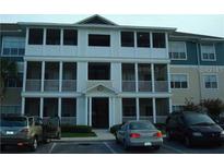 Three-story condo building with screened in porches and visible parking area at 4802 51St W St # 2010, Bradenton, FL 34210