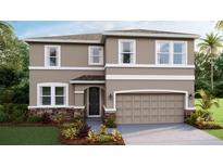 Charming two-story home featuring neutral colors, stone accents, and a welcoming two-car garage at 5623 Silver Moonlight Dr, Palmetto, FL 34221