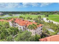 Stunning aerial view of condo community with golf course and lush landscaping at 7334 Regina Royale # 74, Sarasota, FL 34238