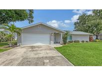 Charming single-story home featuring an attached garage, well-maintained lawn, and freshly painted exterior at 755 Taplow Rd, Venice, FL 34293