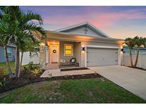 Beautiful dusk view of a single-story home with inviting entrance and landscaped yard at 867 Bacon Ave, Sarasota, FL 34232